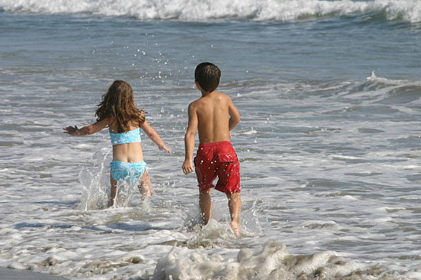 at play on the beach stock photo