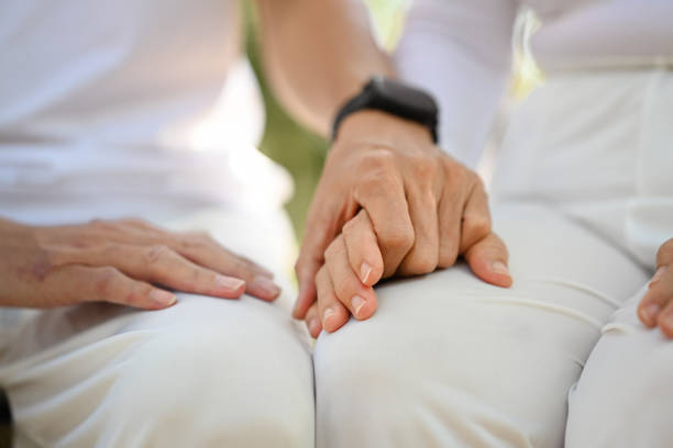Close-up of couple holding hands in a spa