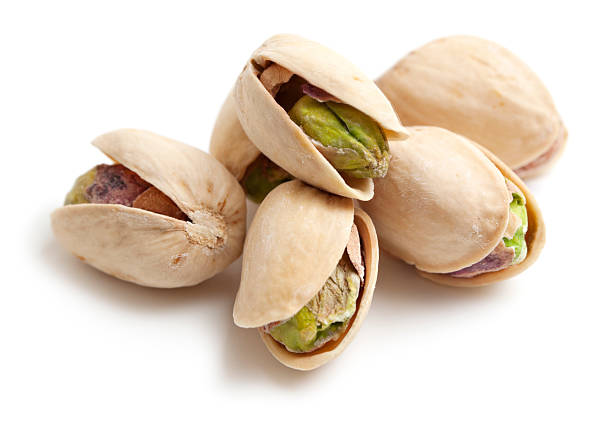 Pistachios Pistachio nuts on white background Pistachio stock pictures, royalty-free photos & images