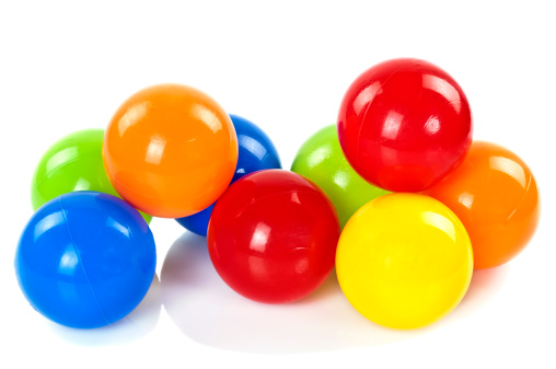 Multi-colored fitget ball connected in the shape of a heart on a white background.