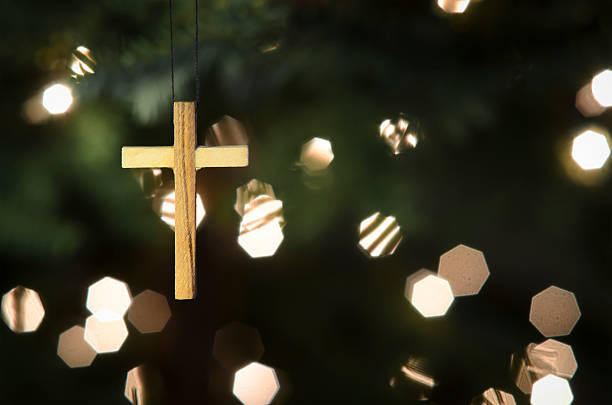 Cross Ornament on Christmas Tree stock photo