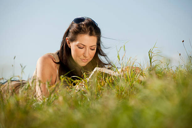 istock Woman reading outdoor 184926351