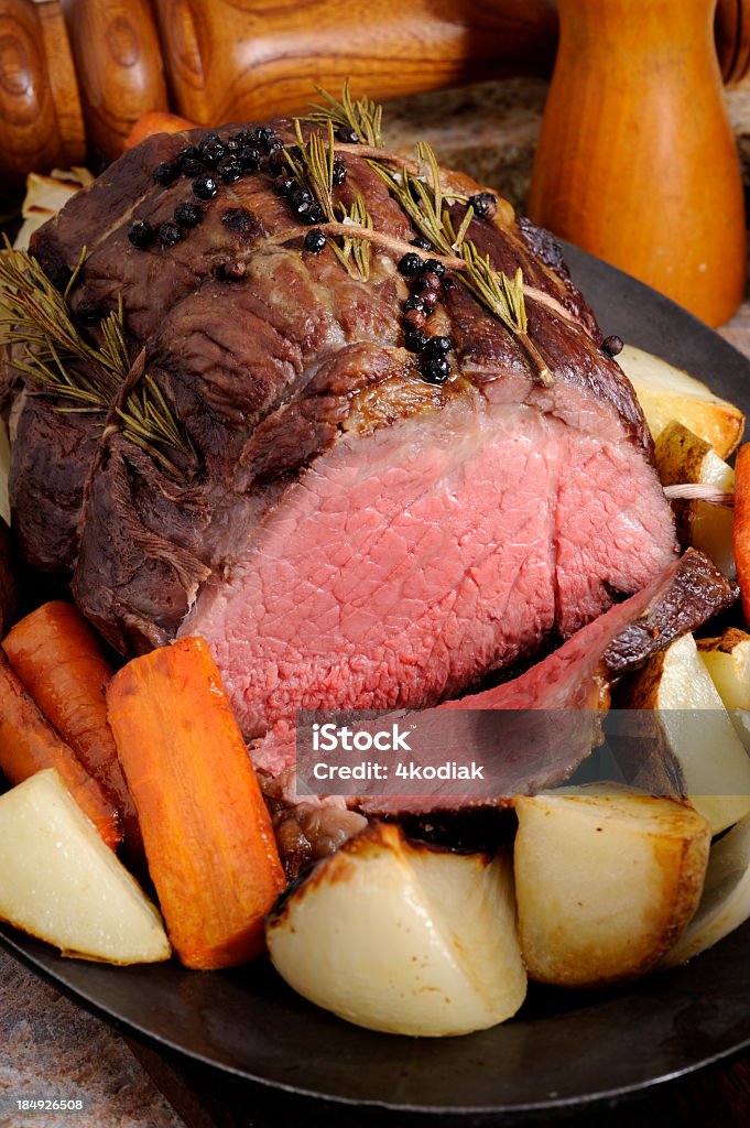 Roasted Beef Roasted Sirloin Tip with Rosemary and peppercorns. Carrot Stock Photo