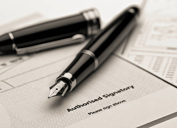 Fountain pen on legal document. stock photo