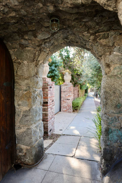 istock Stone clock tower with arched walkway over the sidewalk 1849273377