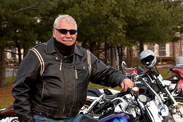 istock Cold weather biker posing with motorcycle on a cool day 184927582