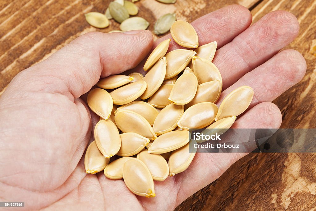 Pumpkin seed Closeup of human hand holding heap of pumpkin seed; Adobe RGB color space;see other similar images: Arrangement Stock Photo