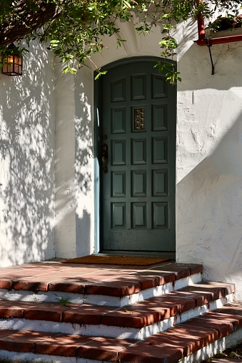 Mediterranean style building with decorative wood front door