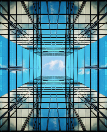 Close up of a business bank complex. Glass walls and windows reflecting the sky. Modern different skyscrapers