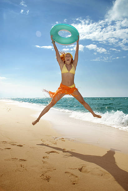 istock Jump of happiness on the beach 184928511