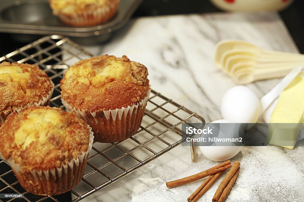 Baking Muffins muffins on cooling rake with ingredients to the side Cinnamon Stock Photo