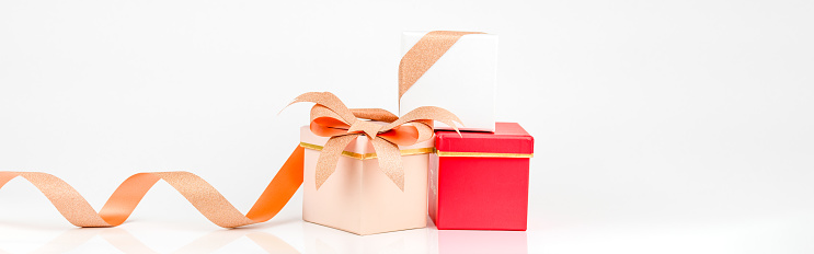 Gift box on orange color, directly above.