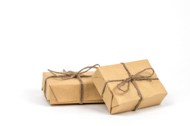 istock Crafted brown gift boxes wrapped in crafted paper. Christmas holiday greeting postcard template. 1849290400
