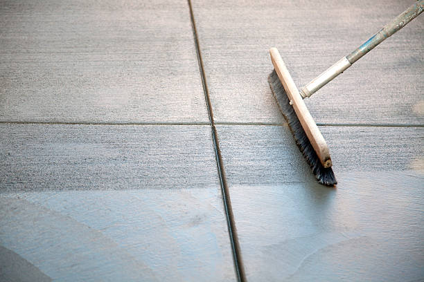 A concrete patio with brush on top stock photo
