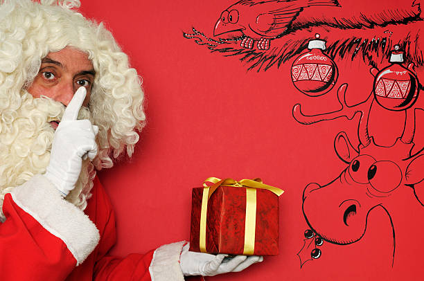 istock Santa Claus Holding Gift 184929351