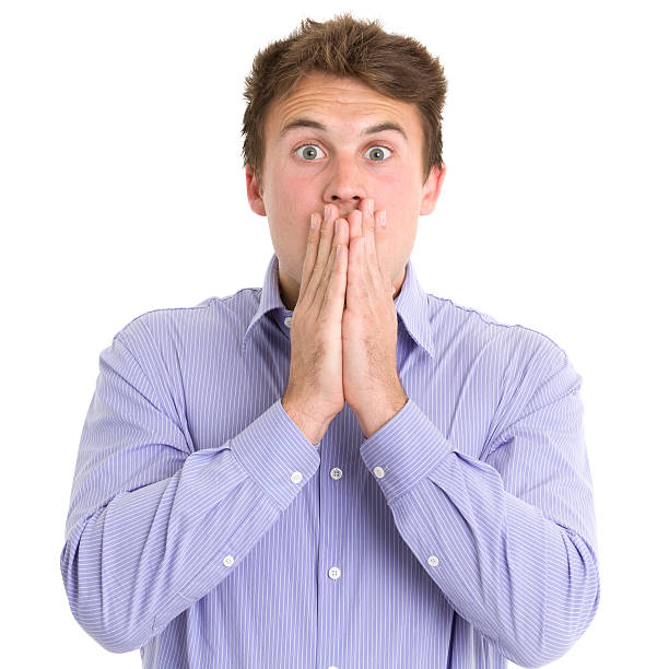 istock Shocked Young Man Covers Mouth 184929629