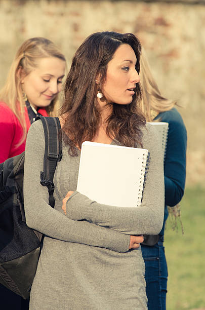 istock Brunette female college student outdoors holding a book 184929980
