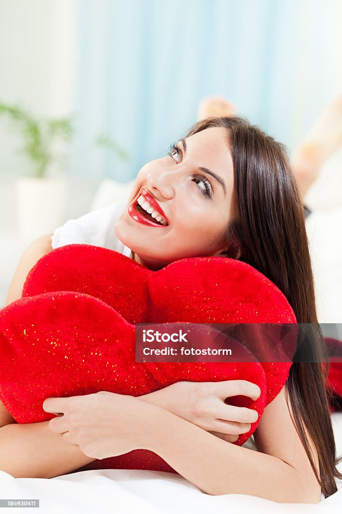 Girl with heart pillow Adult Stock Photo