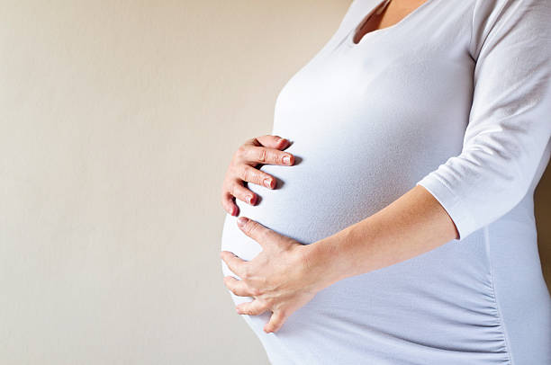 istock Pregnant Woman Holding Her Belly 184930668
