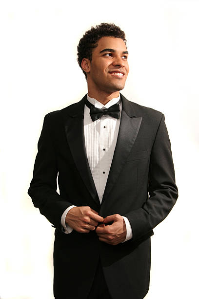 Happy prom date Young minority guy in a tuxedo isolated on white bow tie photos stock pictures, royalty-free photos & images