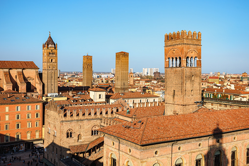 Bologna, Italy - March 5, 2023: Rooftops and towers of famous buildings on Piazza Maggiore - historical square in center of Bologna, Italy