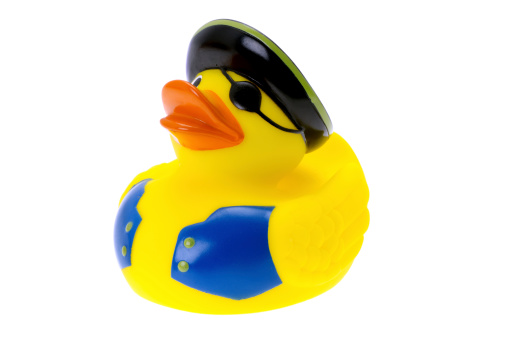 A rubber duck dressed like a pirate - studio shot with a white background