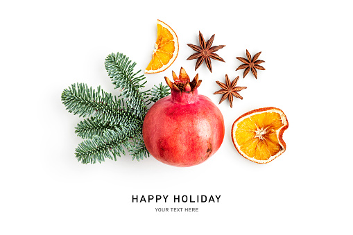 Fir tree branch, pomegranate, orange slice and anise stars isolated on white background. Christmas decoration. Holiday symbol. Creative layout. Design element. Flat lay, top view
