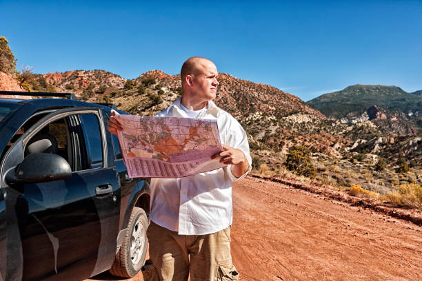 istock Motorist Lost in The Desert with Map 184932118