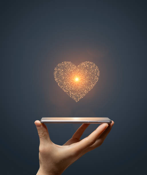 istock Circuit board heart symbol on hand holding smartphone 1849322735