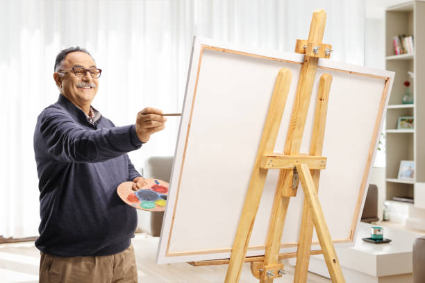 istock Happy mature man painting on a canvas at home 1849326437
