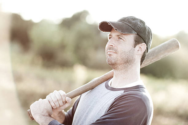 istock Vintage Baseball Player Standing Outdoors With Bat on Shoulder 184933028