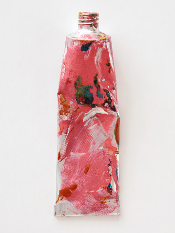 Closeup view of paint tube over white background