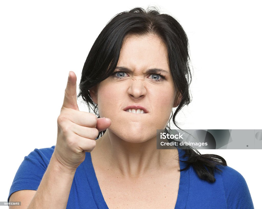 Angry Young Woman Shakes Finger Portrait of a young woman on a white background. Cruel Stock Photo