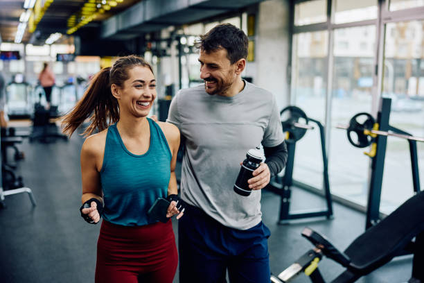 istock Happy athletic couple talking while walking out through the gym. 1849342293