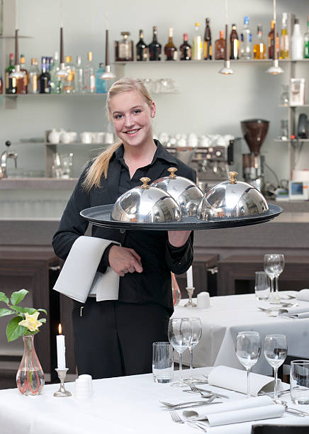 istock waitress holding serving tray in restaurant 184934414
