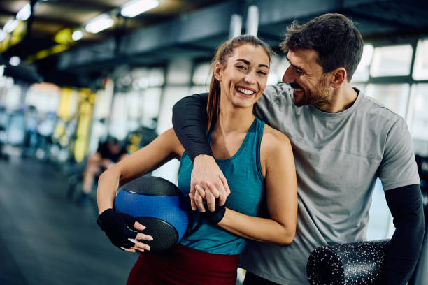 istock Happy athletic couple working out together in a gym. 1849347723