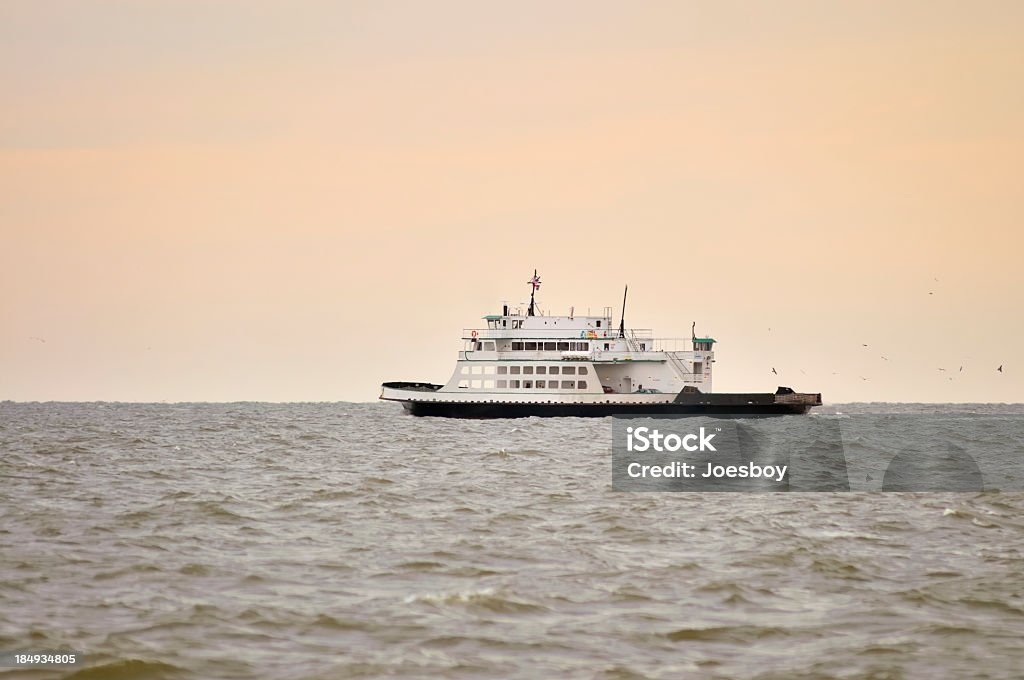 Ocracoke Cedar Point Ferry Midway to Ocracoke island, the Ocracoke to Cedar Point ferry passes by in the late afternoon winter light on the Pamlico Sound. The ferry is almost empty since tourist season has long passed and spring is long time off. Color Image Stock Photo