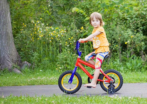istock little girl riding a bicycle 184935254