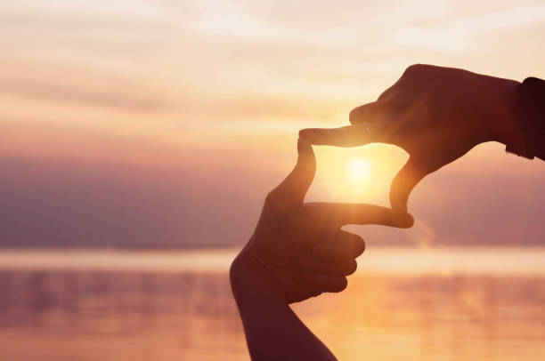 istock Finding inspiration and goals. A woman's hands create a frame and focus with the sunlight shining brightly in the morning 1849353103