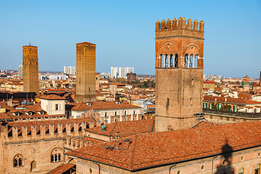 Bologna, Italy - March 5, 2023: Towers above medieval buildings on Piazza Maggiore - historical square in center of Bologna, Italy