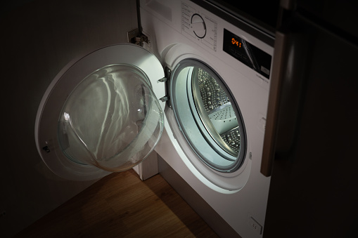 A washing machine with open door at night