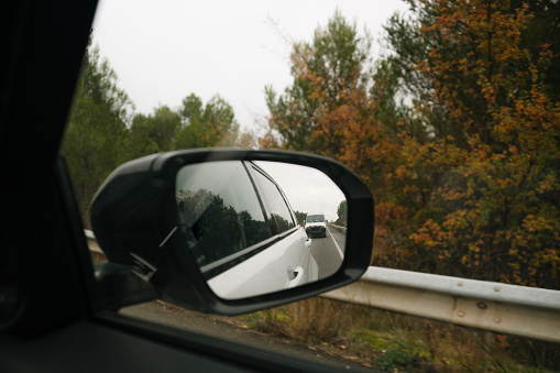 Traffic behind a car as seen from a side view mirror