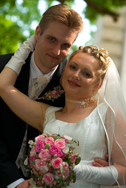 istock bride and groom looking at the camera 184935714