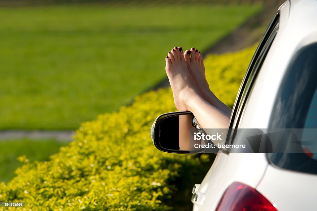 Woman taking a break in the country with feet out car window Take a break Car Stock Photo