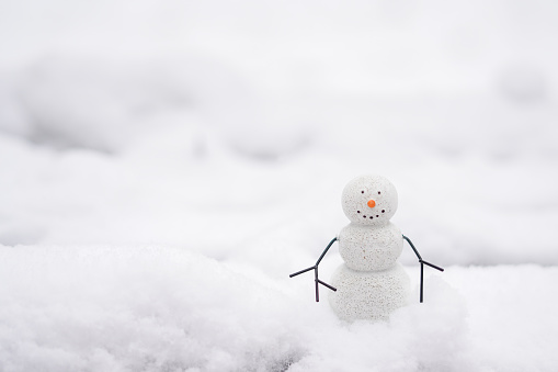 A Happy Snowman on the street staying in the snow, white background with copy space