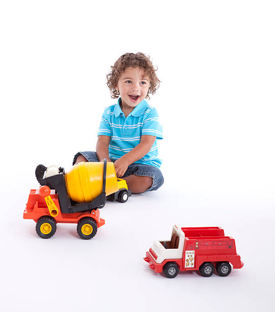 colorful truck cement (concrete) mixer plastic toy on the sand dunes