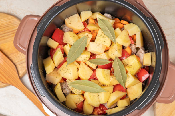 istock Modern, light multi cooker with products. Cooking stewed potatoes with meat in multicooker. Close-up top view of multi cooker with vegetables and meat. 1849366076