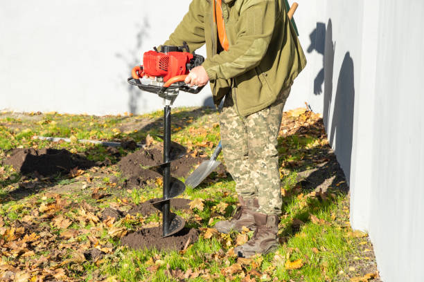 istock Gardener using tools hand-held soil hole drilling machine or portable manual earth auger. 1849367701