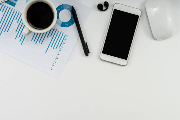 istock White business office desk with smartphone, cup of coffee, financial chart and other tools for work. 1849367708