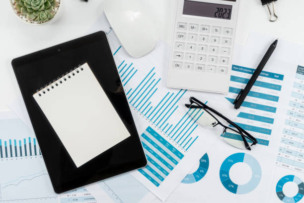 istock Office workplace with business graphs, notepad, calculator, mannifying glass and smartphone. Top view. 1849368255
